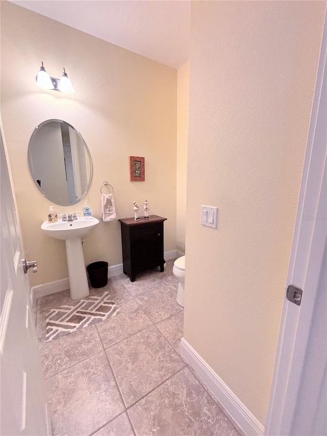 bathroom featuring tile floors and toilet