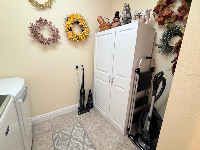 laundry area featuring cabinets, light tile floors, and washer and dryer