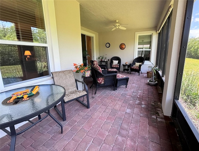 sunroom / solarium featuring ceiling fan