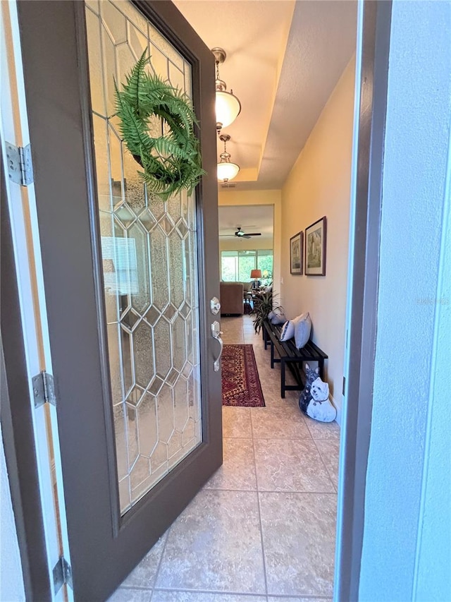 tiled foyer entrance featuring ceiling fan