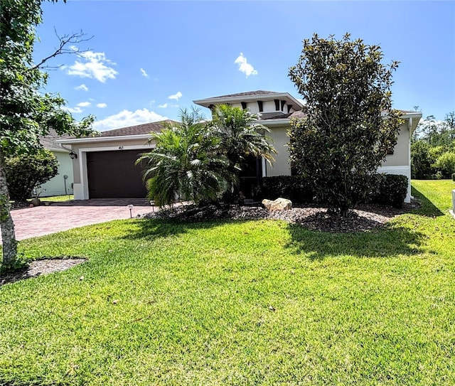 view of front of house with a front yard and a garage