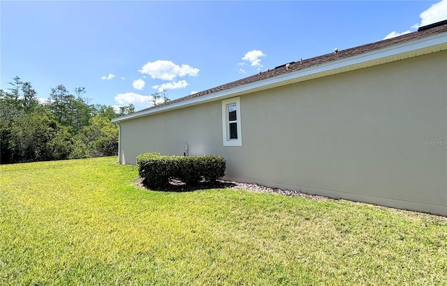 view of side of home featuring a lawn