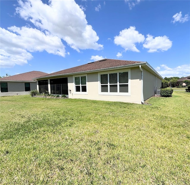 rear view of property with a lawn