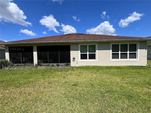 rear view of house featuring a yard