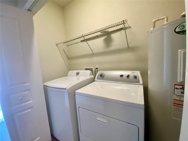 laundry room featuring hookup for a washing machine, water heater, and washer and dryer