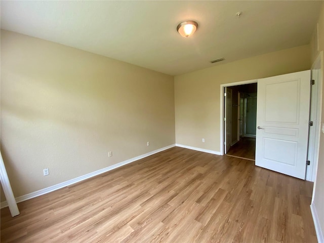 spare room with wood-type flooring