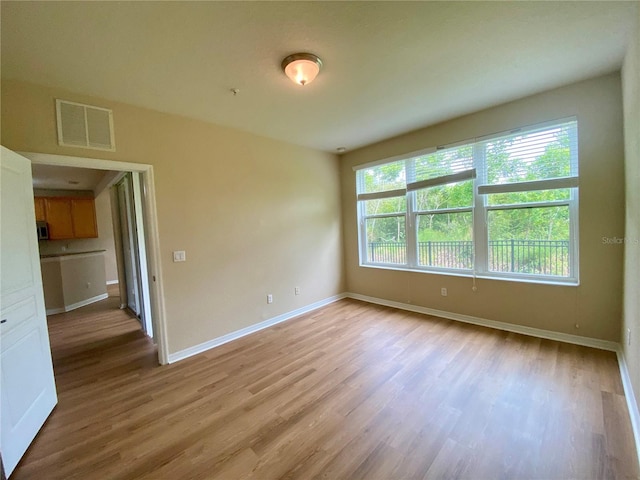 unfurnished room featuring hardwood / wood-style flooring