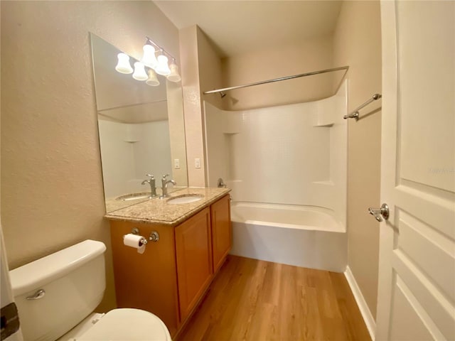 full bathroom featuring  shower combination, hardwood / wood-style flooring, toilet, and large vanity