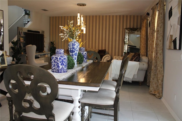 dining room featuring a chandelier and tile floors