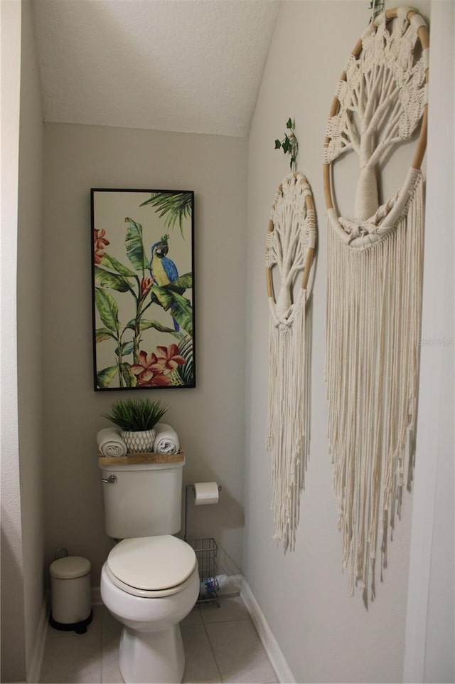 bathroom featuring toilet and tile floors