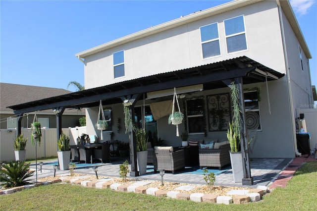 rear view of property with a patio area and outdoor lounge area