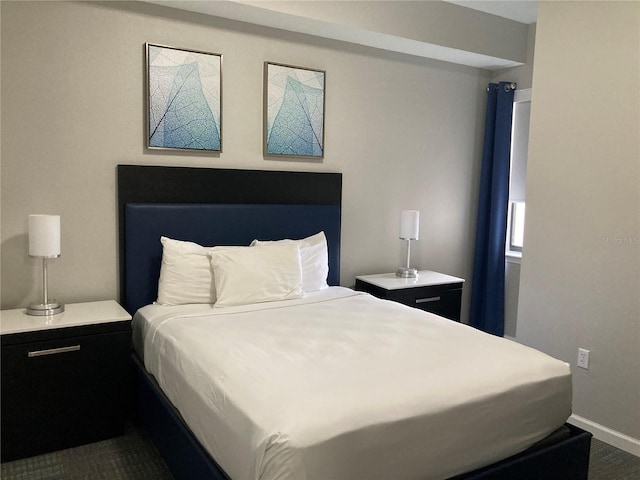 bedroom featuring dark colored carpet