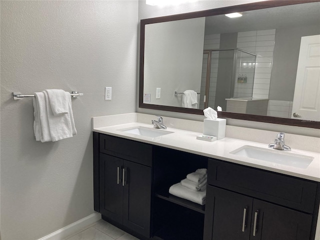 bathroom with tile floors, dual vanity, and a shower with shower door