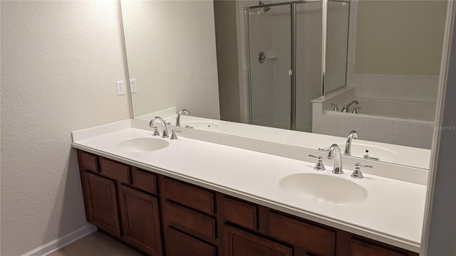 bathroom featuring independent shower and bath, tile floors, and double sink vanity