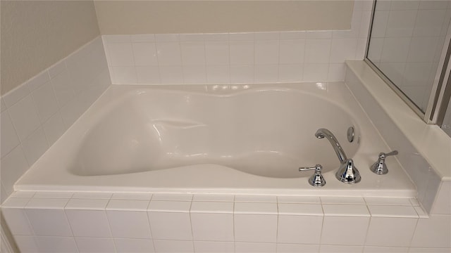 bathroom featuring tiled bath