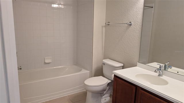 full bathroom featuring tile flooring, tiled shower / bath, vanity, and toilet