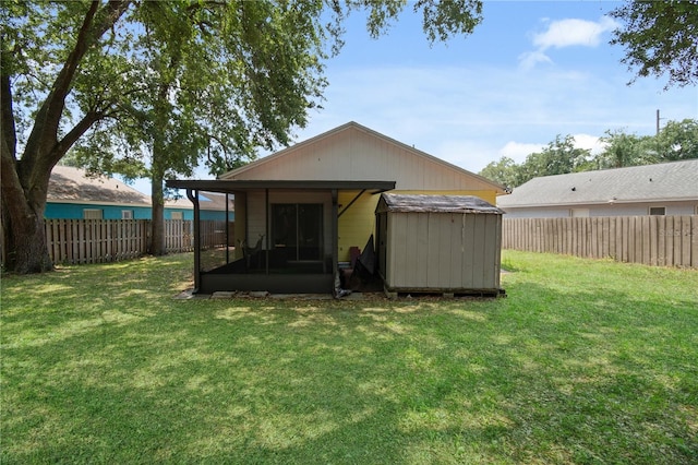 rear view of house featuring a storage unit and a lawn