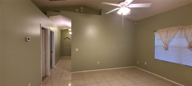 unfurnished room featuring ceiling fan, vaulted ceiling, and light tile patterned flooring