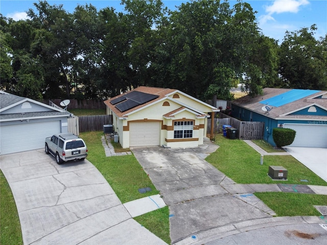 ranch-style home with central air condition unit, a garage, an outdoor structure, and a front yard