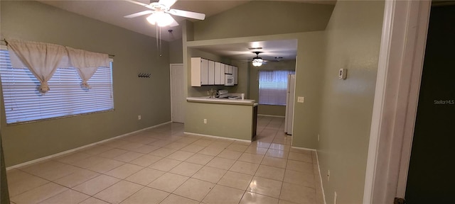 interior space featuring lofted ceiling, light tile patterned flooring, and ceiling fan