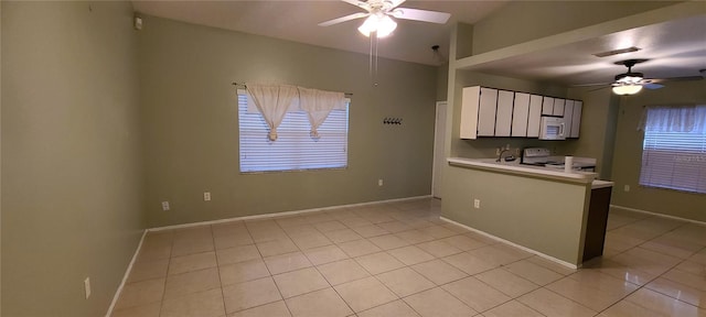 kitchen with white cabinetry, white appliances, light tile patterned floors, ceiling fan, and vaulted ceiling