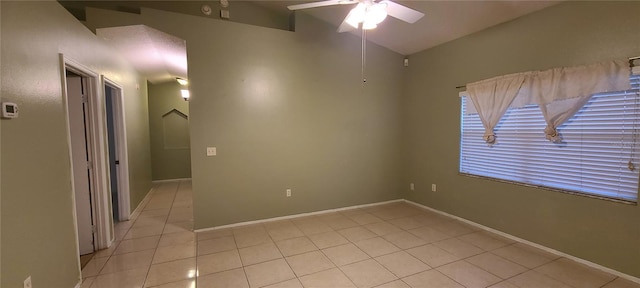 spare room with ceiling fan and light tile patterned flooring