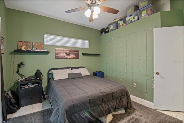 bedroom featuring light tile patterned floors and ceiling fan