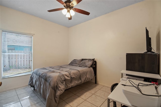 bedroom with ceiling fan and light tile patterned flooring