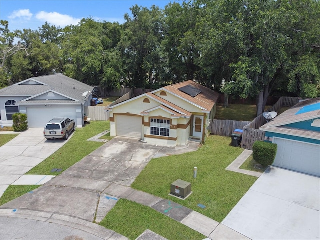 view of front of home featuring a front yard and a garage