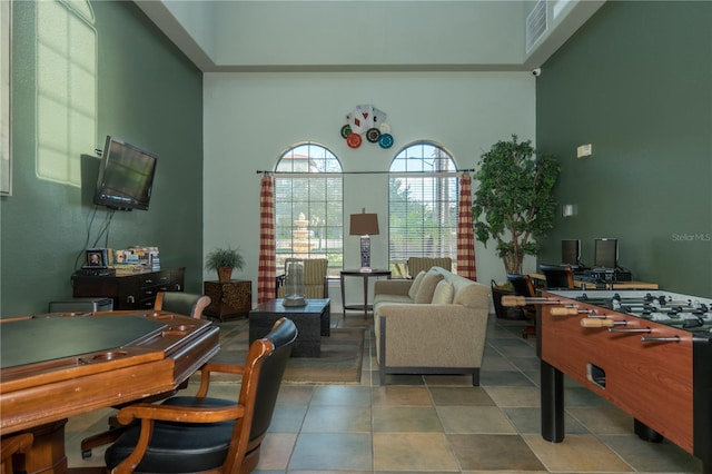 tiled office featuring a towering ceiling