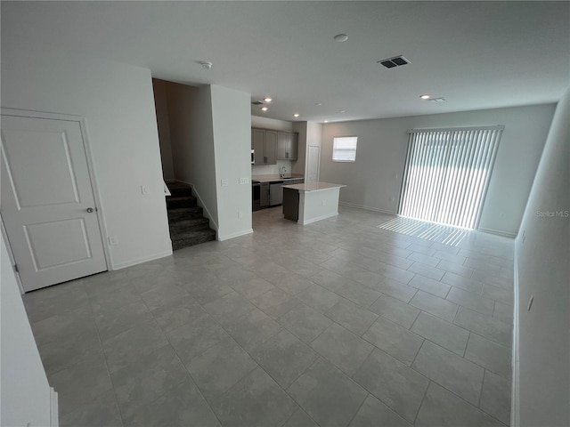 unfurnished living room with light tile floors