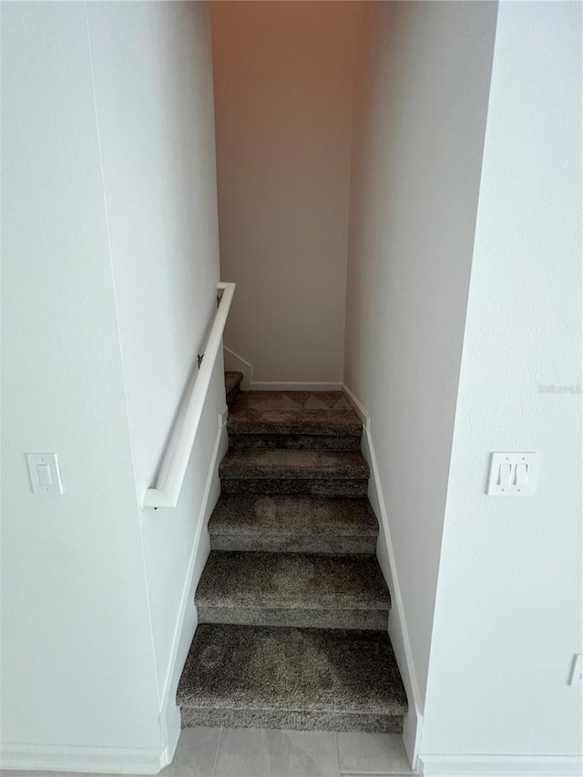 stairway featuring tile floors