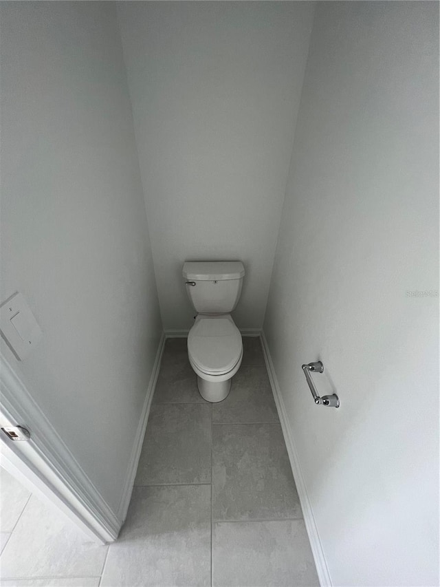 bathroom with toilet and tile floors