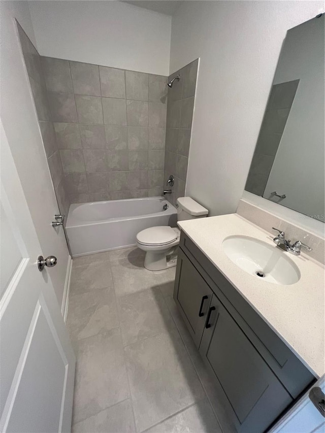 full bathroom featuring toilet, tiled shower / bath combo, tile floors, and oversized vanity