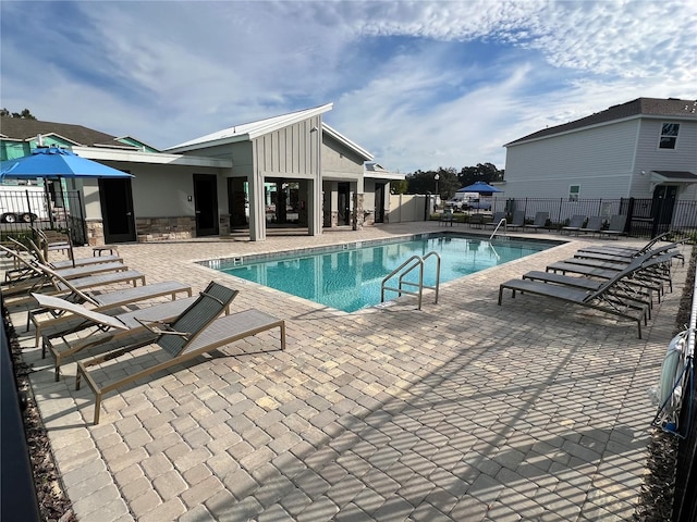 view of swimming pool with a patio