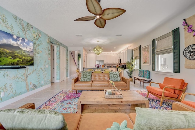 living room with light tile patterned flooring and ceiling fan with notable chandelier