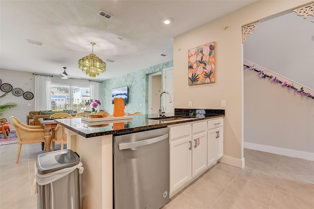 kitchen with dishwasher, white cabinets, sink, ceiling fan, and a textured ceiling