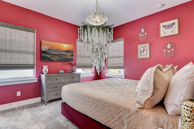 carpeted bedroom with an inviting chandelier