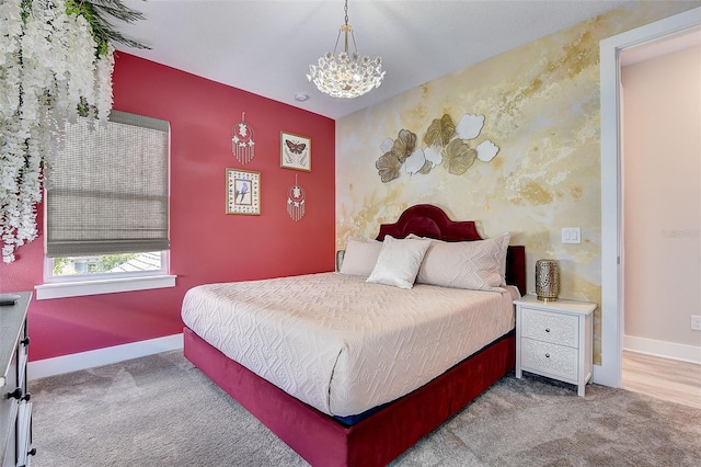 bedroom featuring carpet flooring and a chandelier