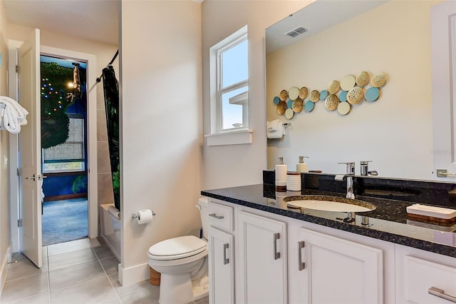 full bathroom featuring tile patterned flooring, shower / bath combo, vanity, and toilet