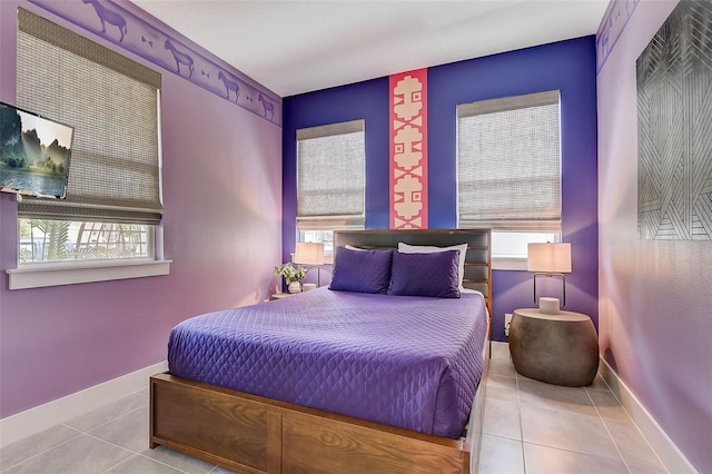 tiled bedroom with multiple windows