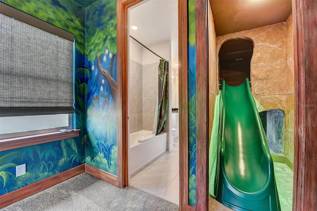 bathroom with tile patterned flooring and shower / bath combo