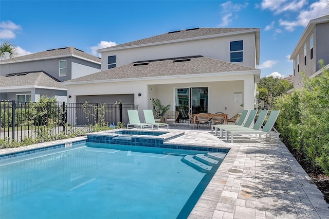 back of house featuring a patio area and a swimming pool with hot tub