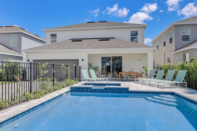 view of swimming pool with a patio area and an in ground hot tub