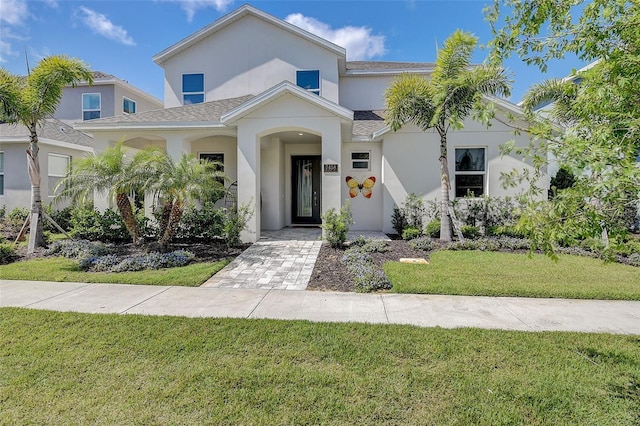 mediterranean / spanish house featuring a front lawn