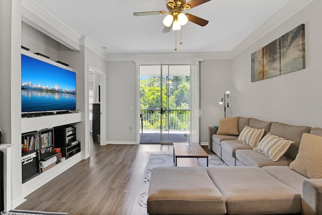 living room featuring a textured ceiling, ceiling fan, hardwood / wood-style flooring, and ornamental molding