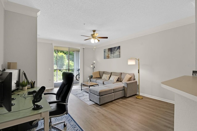 office space featuring crown molding, a textured ceiling, ceiling fan, and hardwood / wood-style floors