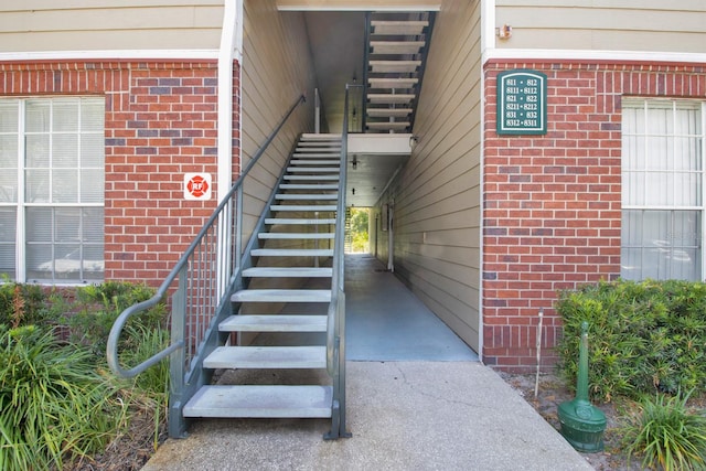 stairs featuring wood walls