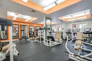 workout area featuring a raised ceiling and visible vents