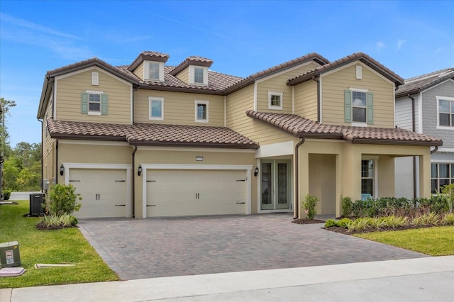 mediterranean / spanish-style home featuring cooling unit and a garage